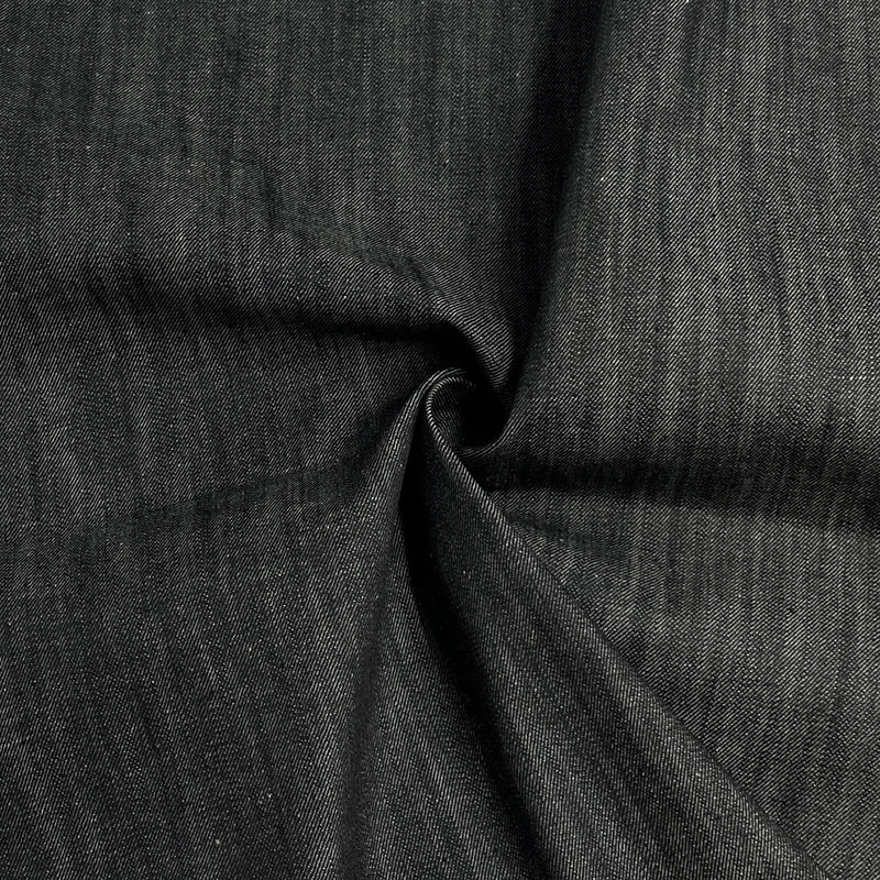 Black selvedge denim with mild stretch rolled into a swirl