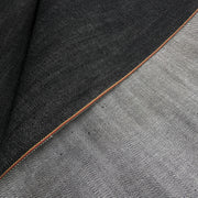Closeup of the selvedge of a black selvedge edge denim 
