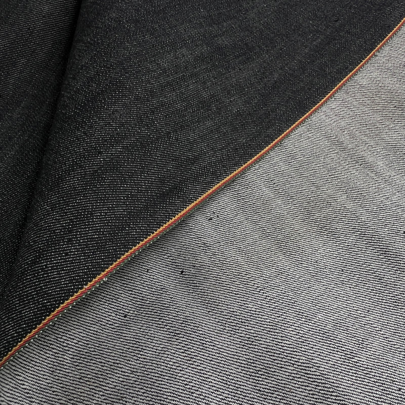 Closeup of the selvedge of a black selvedge edge denim 