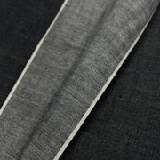 Closeup of selvedge edge of black yarn dye selvedge denim.