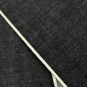 Closeup of face and self-finished selvedge of yarn dye black selvedge denim. 