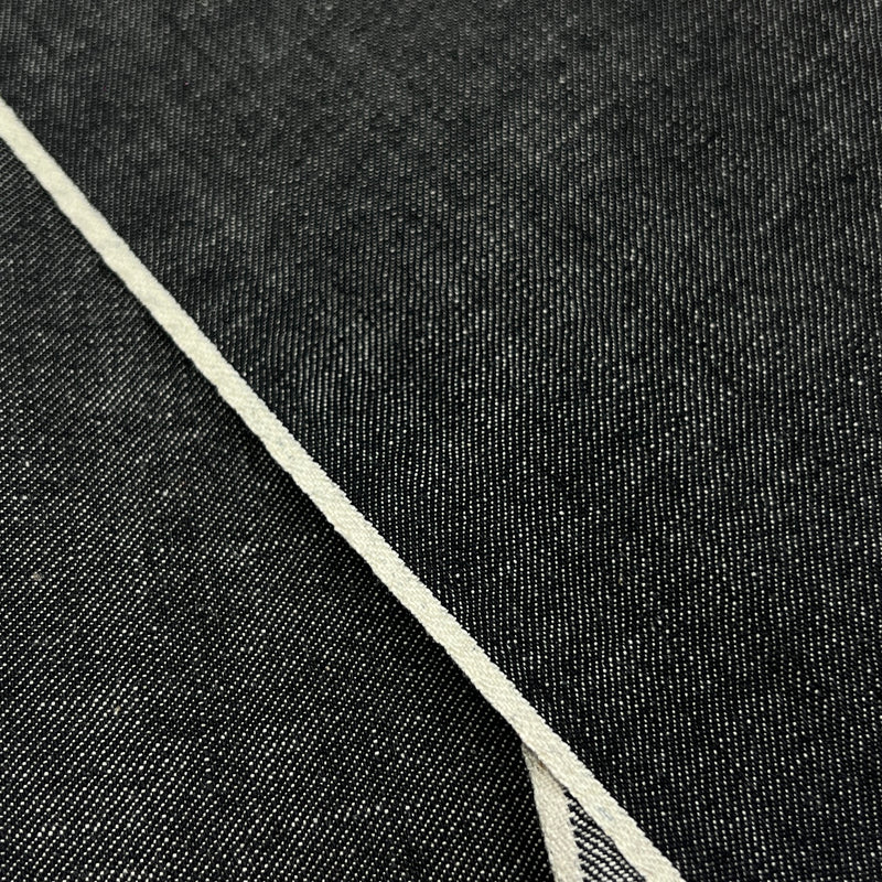 Closeup of face and self-finished selvedge of yarn dye black selvedge denim. 