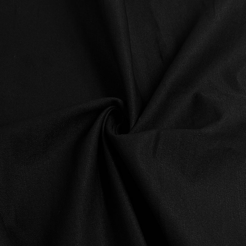 A close-up of draped black fabric with soft folds and a subtle sheen, filling the entire frame.