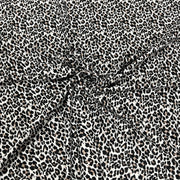 Black and white leopard print fabric with a gathered center, showing the texture and pattern details.