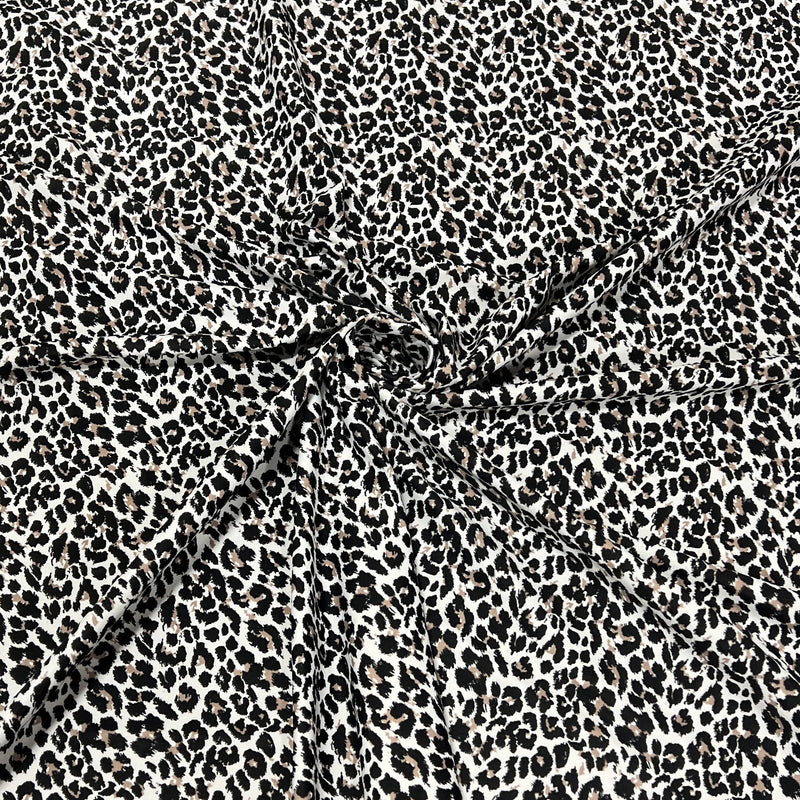 Black and white leopard print fabric with a gathered center, showing the texture and pattern details.