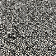 A close-up of a black and off-white leopard print fabric pattern filling the entire frame.