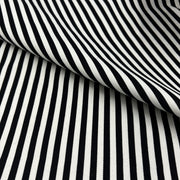 Black and white striped fabric with a diagonal fold showing the texture and pattern.