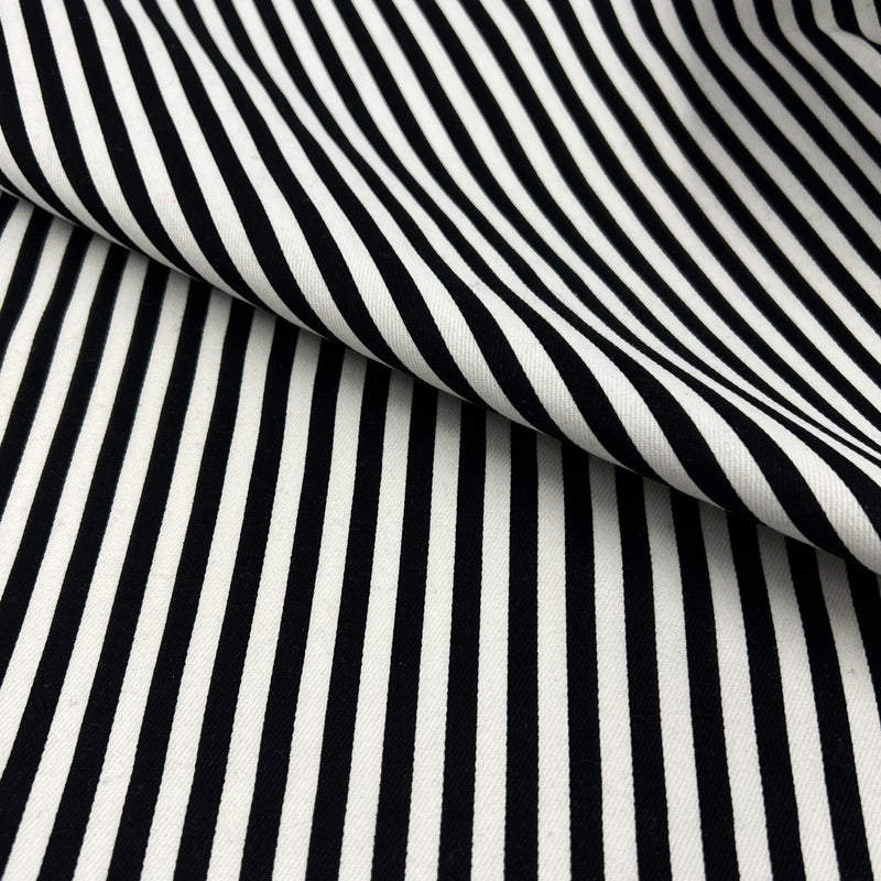 Black and white striped fabric with a diagonal fold showing the texture and pattern.