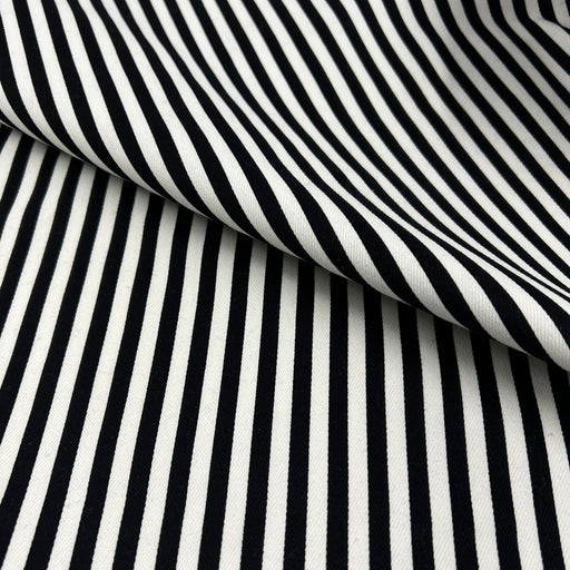 Black and white striped fabric with a diagonal fold showing the texture and pattern.