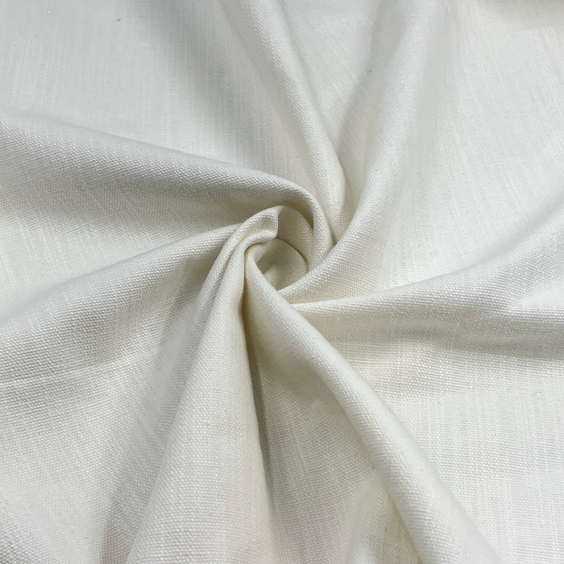 A close-up of off-white woven fabric with a soft, textured surface, arranged in a spiral drape to show its texture and drape.