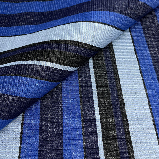 A close-up of a corded upholstery fabric with a striped pattern in shades of blue, navy, black, and light blue.