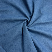 Blue washed denim folded into a swirl showing off soft texture