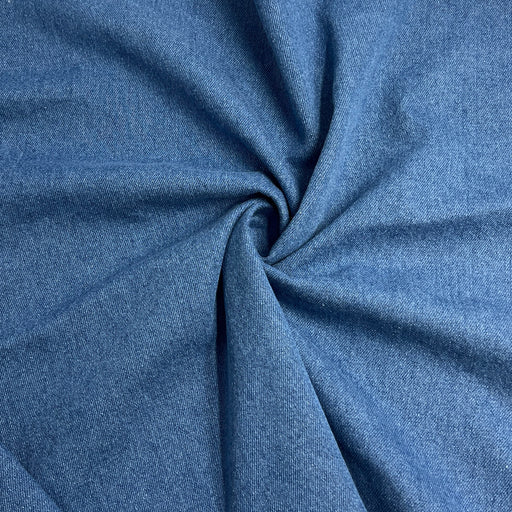 Blue washed denim folded into a swirl showing off soft texture