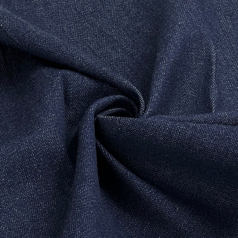 A close-up of dark navy blue textured fabric with a gathered swirl in the center, showing the woven material detail.