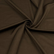 A close-up of draped dark brown fabric arranged in a spiral, showing the material's smooth texture and soft folds.