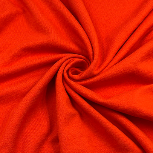 Bright orange-red fabric draped in a spiral pattern, showing a smooth woven texture.