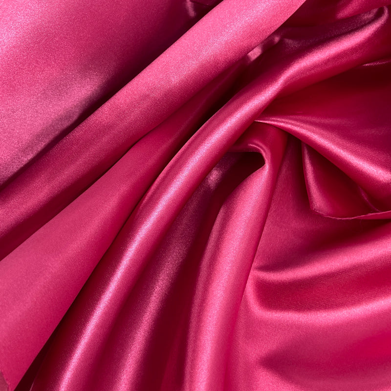 Medium weight bridal satin in a red-toned hot pink color with a moderate drape and structured hand draped to show off texture. 