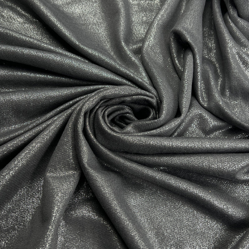 A close-up of draped metallic fabric in a dark charcoal gray color with a subtle shimmering finish, arranged in a spiral pattern.
