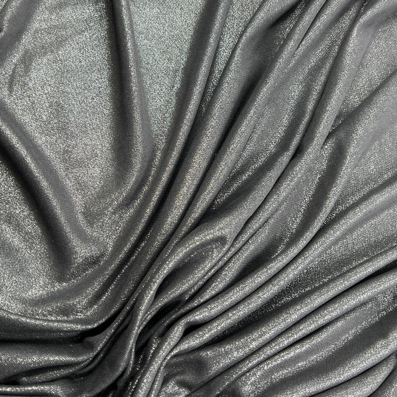 A close-up of draped metallic fabric with a shimmering silver-gray finish and soft folds.