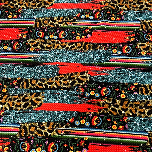 A close-up of a highly textured fabric featuring a complex multicolor pattern with leopard print, glittery silver stripes, red brushstrokes, and small floral motifs.