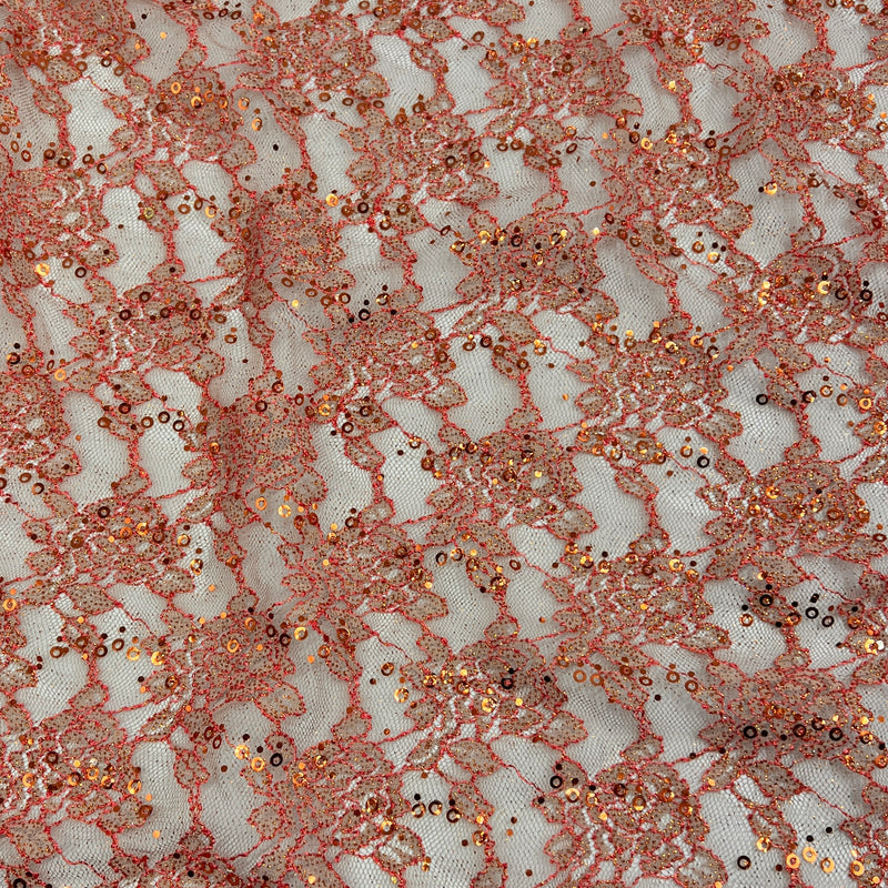Rose gold lace fabric with sequins and metallic embroidery on a white mesh background.