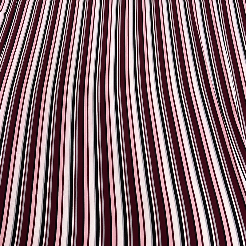 A close-up of a striped fabric pattern featuring vertical wavy stripes in deep burgundy, light pink, white, and thin black lines.