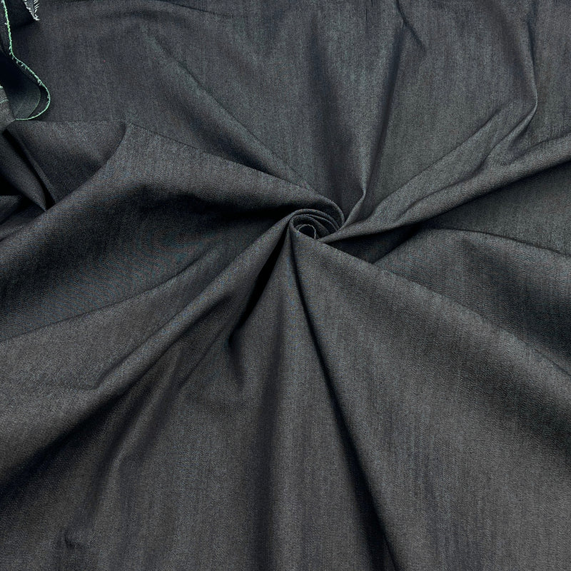 Dark charcoal gray fabric draped in a spiral pattern to show its texture and drape.