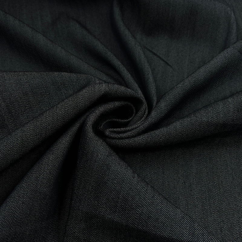A close-up of dark charcoal gray fabric arranged in a spiral drape, showing its fine twill texture.