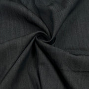 A close-up of dark charcoal gray fabric with a textured weave, arranged in a spiral drape to show its texture and flexibility.