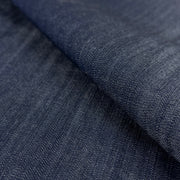 Close-up of dark indigo 100% tencel denim fabric with a subtle sheen