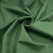 A close-up of dark green linen fabric with a textured weave, arranged in a spiral drape to show its texture and color.