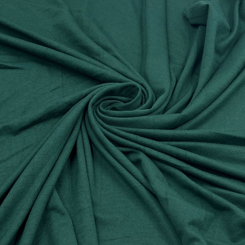 Dark teal green fabric draped in a spiral pattern, showing its soft texture and drape.