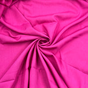 Bright pink fabric draped in a spiral pattern, showing its smooth texture and soft folds.