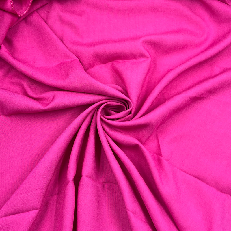 Bright pink fabric draped in a spiral pattern, showing its smooth texture and soft folds.