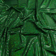 Green sequined fabric with a shimmering, metallic finish, draped in soft folds to show its texture and reflective properties.