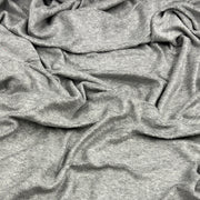 A close-up of draped heather gray fabric with soft folds and a textured, plush surface.