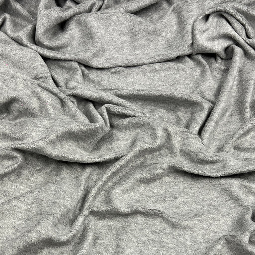 A close-up of draped heather gray fabric with soft folds and a textured, plush surface.