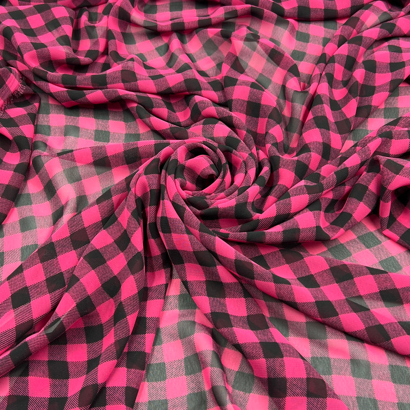 Bright pink and black buffalo plaid fabric draped in a spiral pattern, showing its soft texture and checkered design.