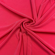 A close-up of bright pink fabric arranged in a spiral drape, showing the material's texture and color.