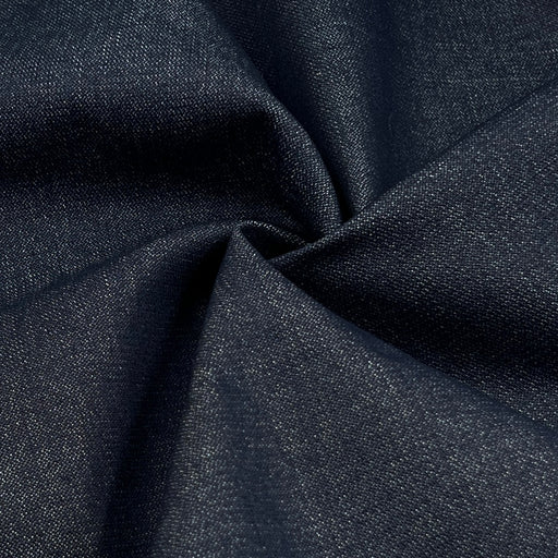 A close-up of dark navy blue textured fabric gathered in the center to show its weave and drape.