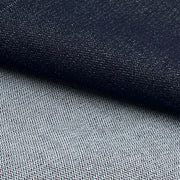 Close-up of a woven fabric texture in two tones: a dark navy section on top and a lighter gray section below, with a diagonal fold separating them.