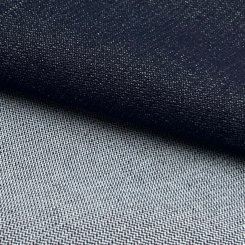 Close-up of a woven fabric texture in two tones: a dark navy section on top and a lighter gray section below, with a diagonal fold separating them.