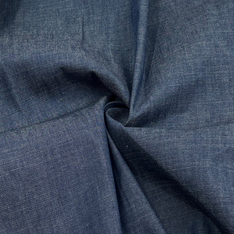 A close-up of dark blue textured fabric with a twisted fold in the center, showing the material's weave and color.
