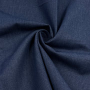 A close-up of dark navy blue fabric with a textured weave, arranged in a spiral drape to show its texture and flexibility.
