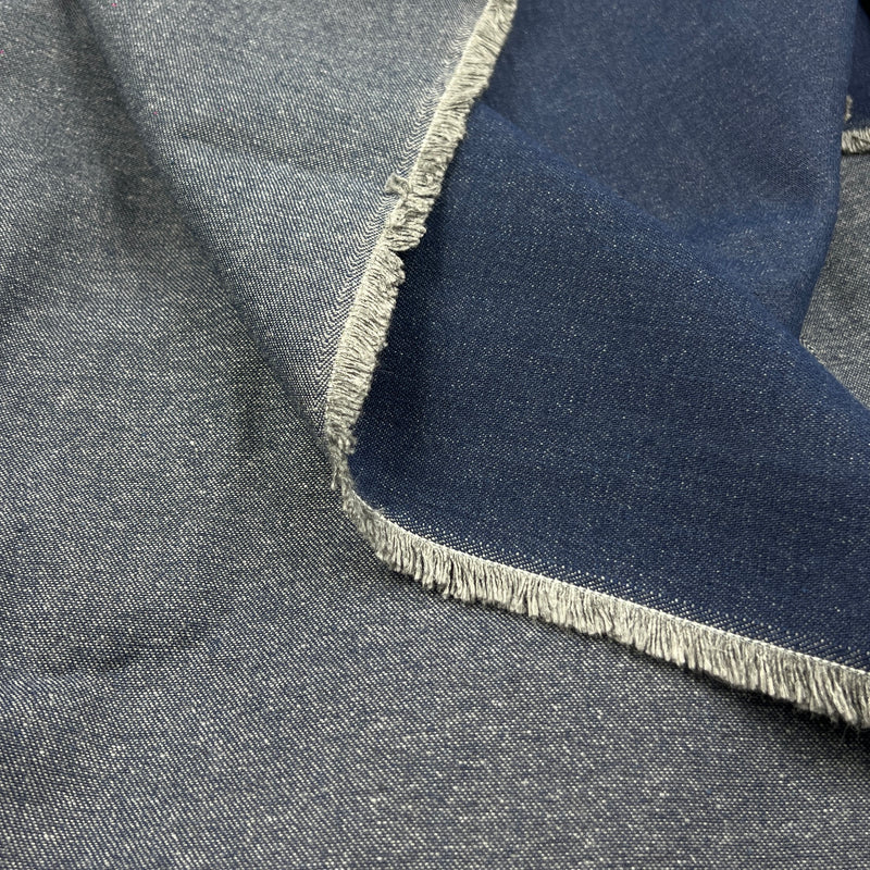 A close-up of folded fabric with a heathered medium gray outer side and a darker navy inner side, finished with frayed edges.