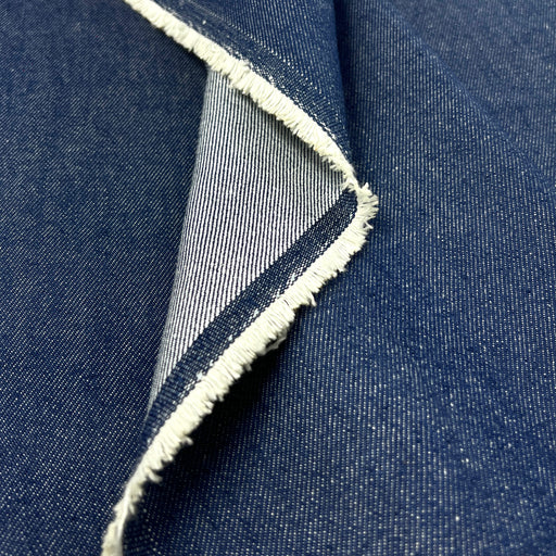 Closeup of indigo cotton denim showing both the face and reverse of the fabric.