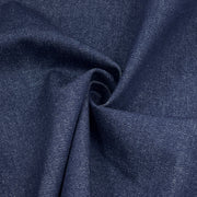 A close-up of dark navy blue fabric with a visible woven texture, arranged in soft folds and a central swirl.