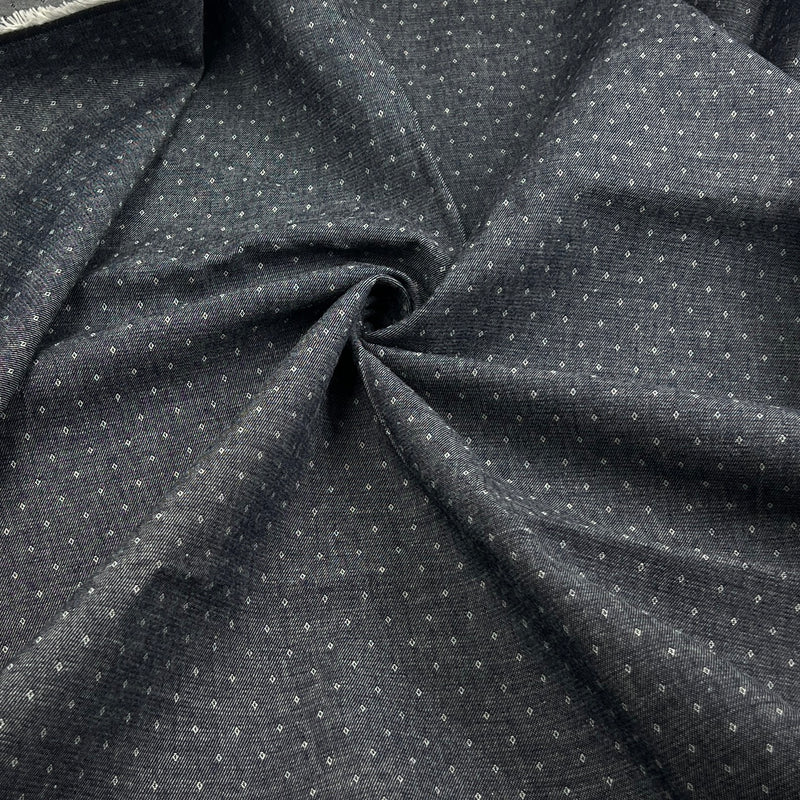 Dark charcoal gray fabric with a small white geometric dot pattern, draped in a central swirl to show texture and drape.