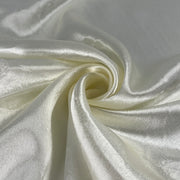 Close-up of white satin fabric with folds