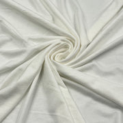 A close-up of off-white or cream-colored fabric arranged in a spiral drape, showing its soft texture and smooth surface.